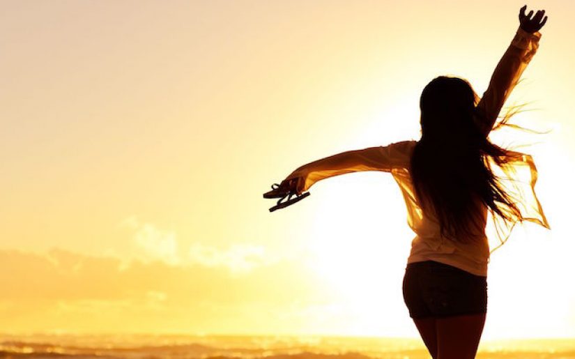 11900499 - carefree woman dancing in the sunset on the beach. vacation vitality healthy living concept